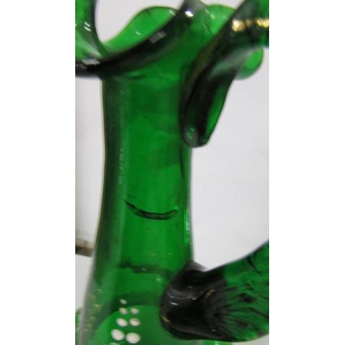 1229 - A green glass claret jug hand decorated with lily of the valley, 30cm< (a/f crack under handle).