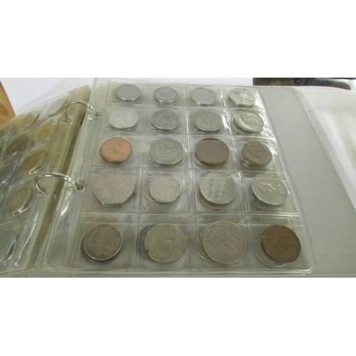 1171 - Two albums of UK and foreign coins.