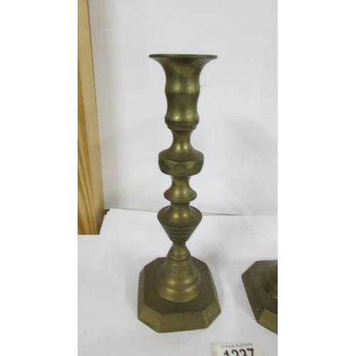 1237 - A pair of Victorian brass candlesticks.