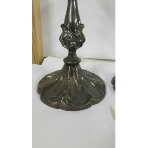 1239 - A pair of ornate silver plate candlesticks.