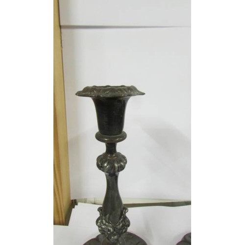 1239 - A pair of ornate silver plate candlesticks.