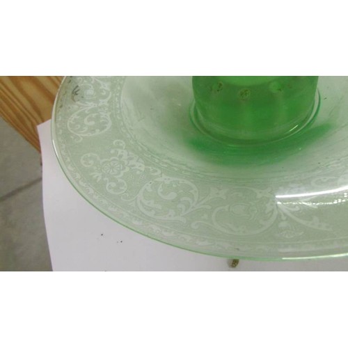 1240 - An art deco green glass flower bowl with engraved rim and centre figure.