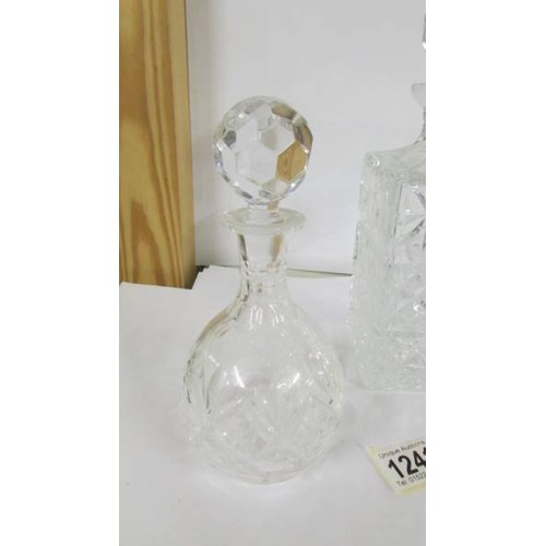 1241 - A heavy cut glass decanter and a smaller example.