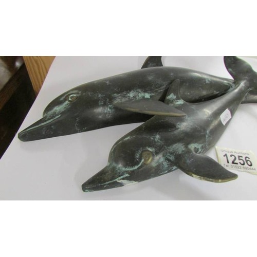 1256 - A bronze dolphin wall plaque.