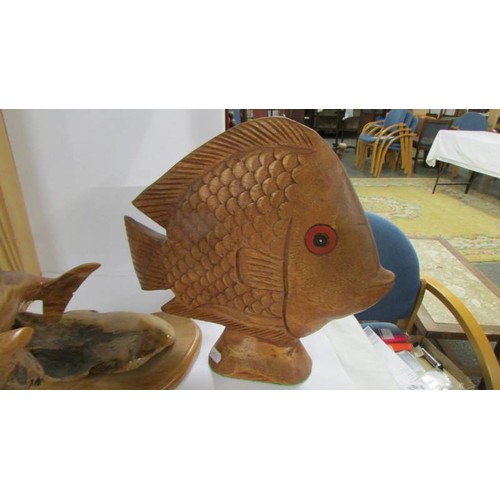 1259 - A carved wood dolphin and another carved fish.