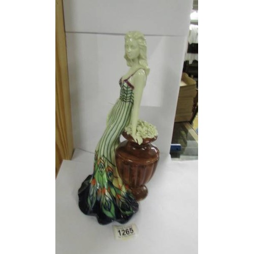 1265 - An Old Tupton ware figure of a woman leaning on an urn,