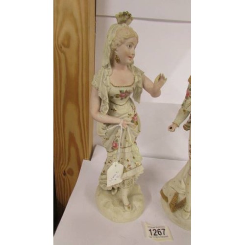 1267 - A good pair of Continental porcelain figures, 34 cm tall.  (There is something missing from the man'... 