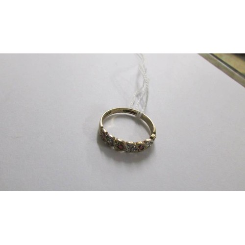 1064 - A 9ct gold ring set garnets size N and a 9ct gold half eternity ring, 3.4 grams total.