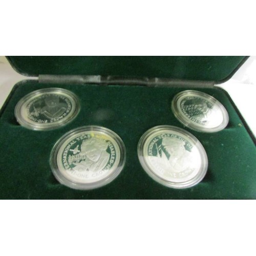 1189 - A cased set of four silver proof crowns, Year of the Disabled and an extra Douglas Bader crown, (Isl... 