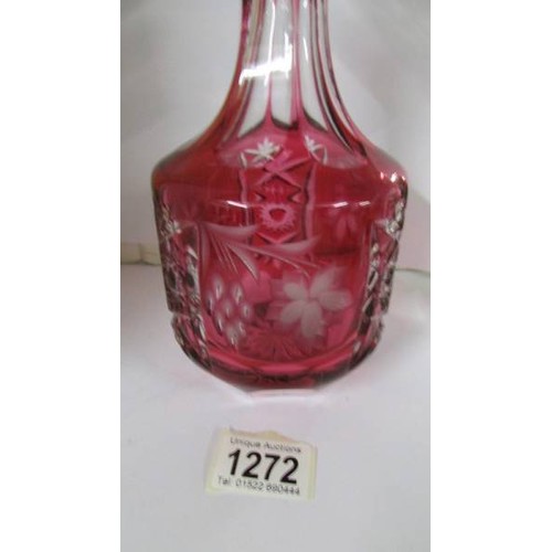 1272 - A red overlaid cut glass decanter.