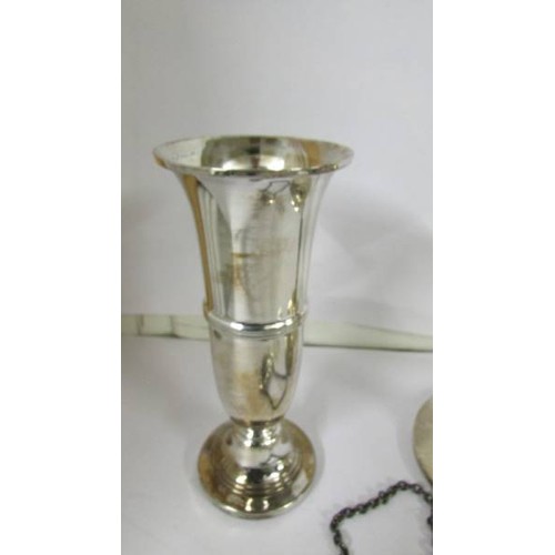 1277 - A silver candle holder, silver spill vase and silver sherry label.