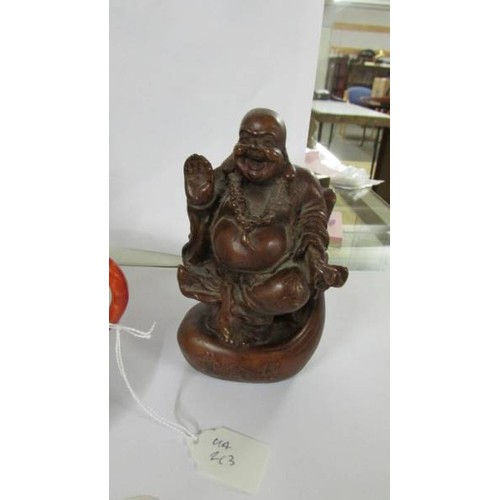 1278 - A Chinese teapot on saucer and a figure of a Buddha,