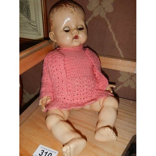 310 - A vintage composition doll.