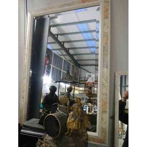 354 - A framed bevel edged mirror, in good condition   COLLECT ONLY.