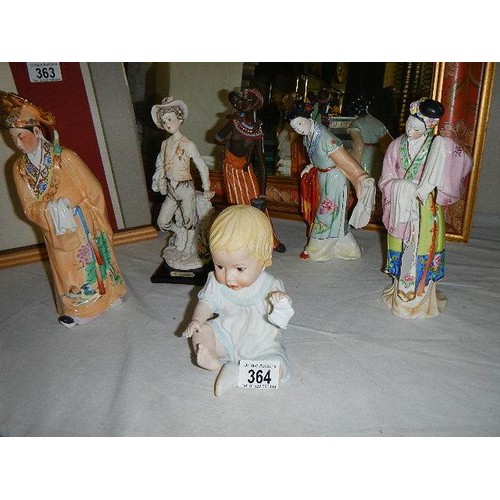 364 - Three Japanese figures, an African figure, a boy and a baby figures.