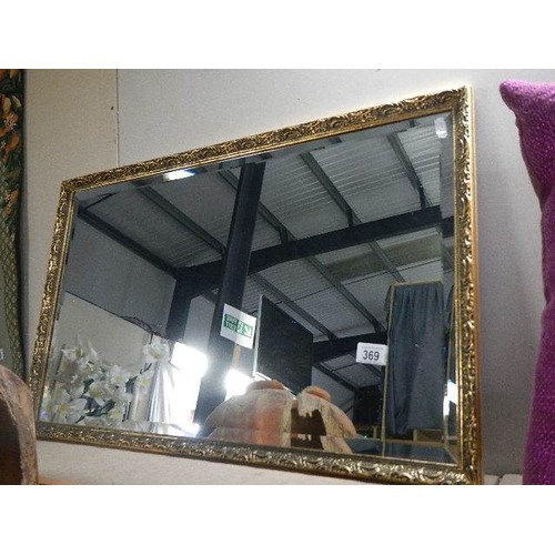 369 - A large gilt framed bevel edged mirror, 82 x 52 cm.   COLLECT ONLY.