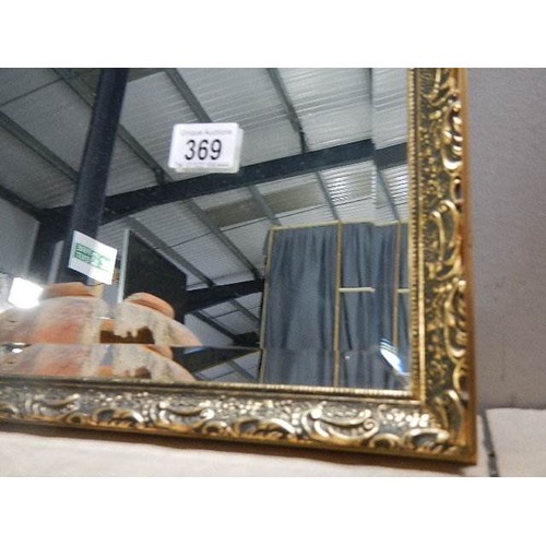 369 - A large gilt framed bevel edged mirror, 82 x 52 cm.   COLLECT ONLY.