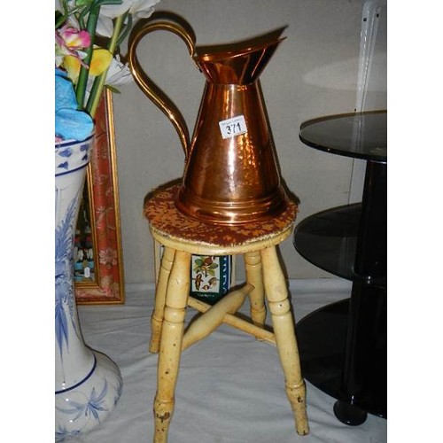 371 - A copper jug and a four legged stools.  COLLECT ONLY.