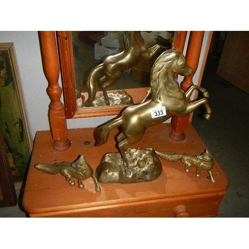 333 - A heavy brass rearing horse and two foxes.