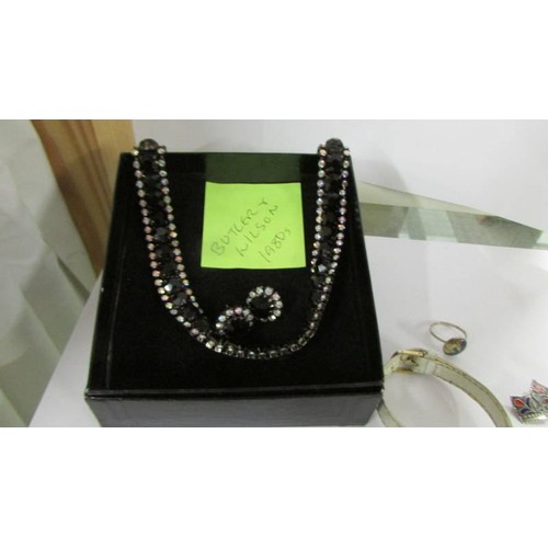 1073 - A vintage 1908's Butler & Wilson choker with earrings set with black crystal stones in original box,... 