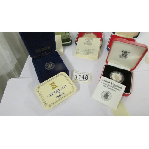 1148 - Three cased silver commemorative crowns and two silver £1 coins with certificates.