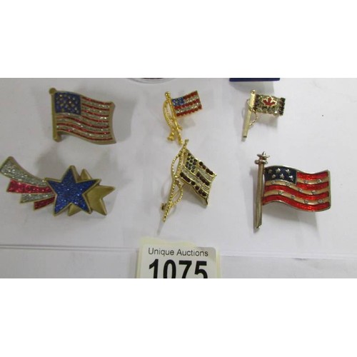 1075 - A quantity of vintage American flag brooches, a Canadian example and a pendant.