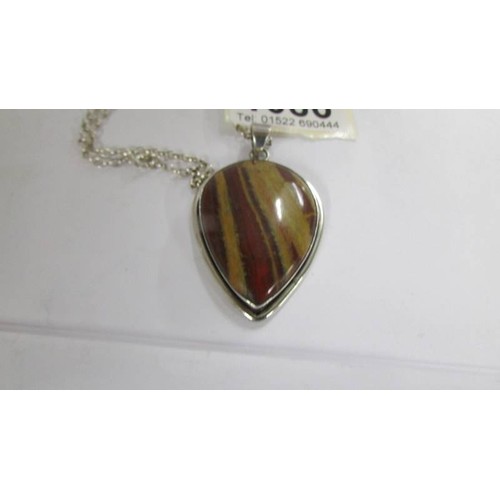 1086 - A Jasper stone pear shaped pendant in silver with attached silver chain.