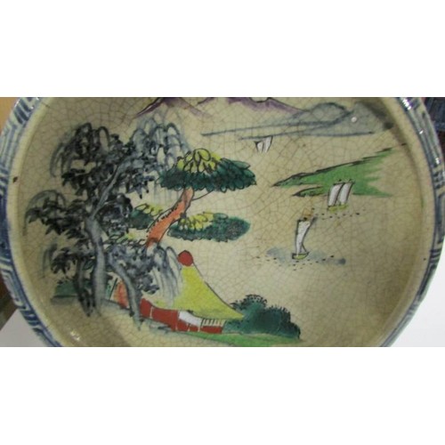 1357 - An early 20th-century hand painted Chinese bowl on 3 feet, impressed mark to bottom, 20.25 cm diamet... 