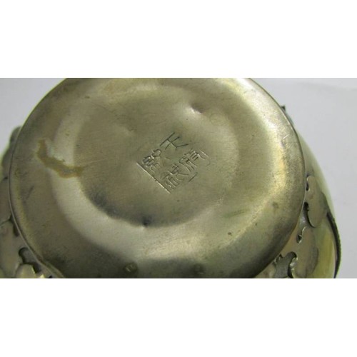 1369 - A Tibetan silver mounted jade tea bowl, impressed mark to base, 11 cm diameter, 5 cm high.