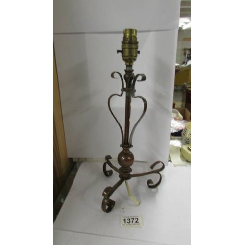 1372 - An Arts and Crafts copper lamp in the style of Benson, 34 cm tall.