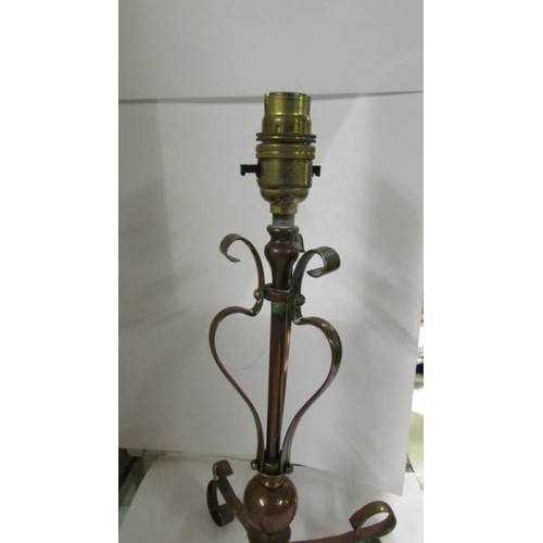 1372 - An Arts and Crafts copper lamp in the style of Benson, 34 cm tall.