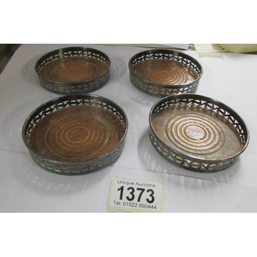 1373 - Four vintage silver plated bottle coasters, 9.5 cm daimeter.