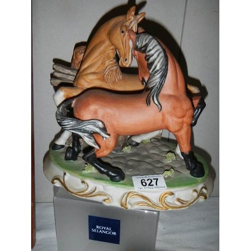 627 - A pair of ceramic fighting horses and a ceramic car.