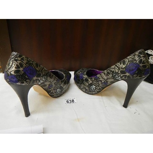 638 - A pair of 'Iron Fist' high heel shoes.