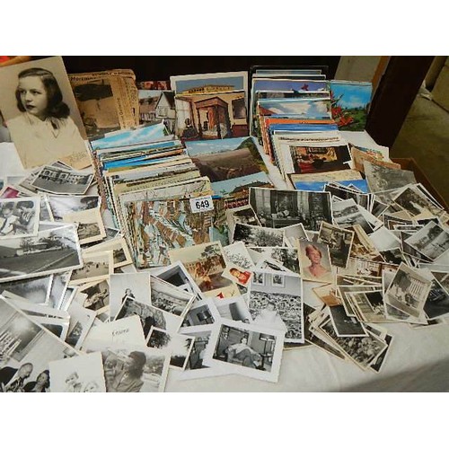 649 - A large mixed lot of postcards and black & white photographs.