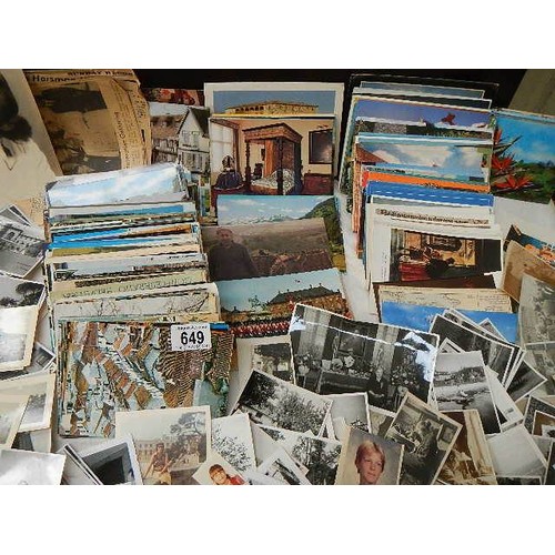 649 - A large mixed lot of postcards and black & white photographs.