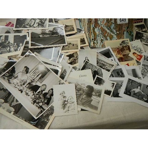 649 - A large mixed lot of postcards and black & white photographs.