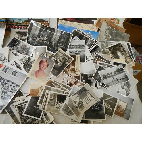 649 - A large mixed lot of postcards and black & white photographs.