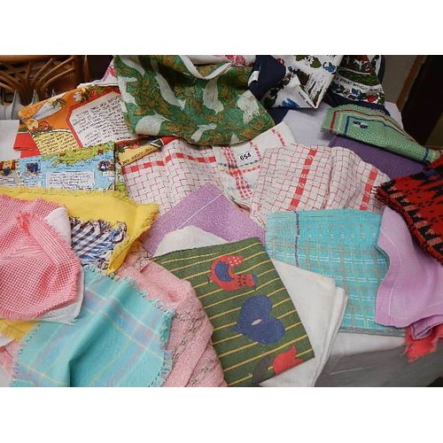 654 - A mixed lot of tea towels etc.,