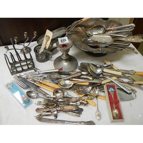 659 - A mixed lot of flat ware, toast rack, candlesticks etc.,