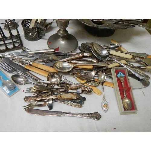 659 - A mixed lot of flat ware, toast rack, candlesticks etc.,