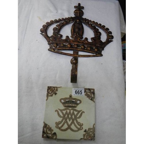 665 - A metal hook in the form of a crown and a Danish armorial tile.