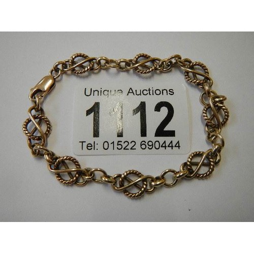 1112 - A 9ct gold fancy rope link bracelet, (tests as 9ct), 9 grams.