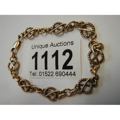 1112 - A 9ct gold fancy rope link bracelet, (tests as 9ct), 9 grams.