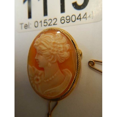 1115 - A 9ct gold female profile cameo brooch with safety chain,