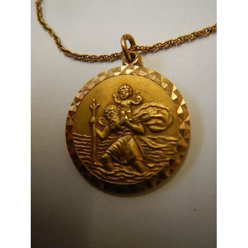 1117 - A 9ct gold St. Christopher on a 9ct gold chain, 9 grams.