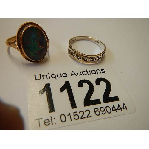 1122 - A 9ct gold ring set fire opal, size J half and a gold and silver ring, size N.