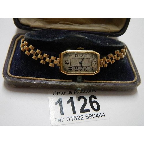 1126 - A 9ct gold ladies wrist watch on metal bracelet.