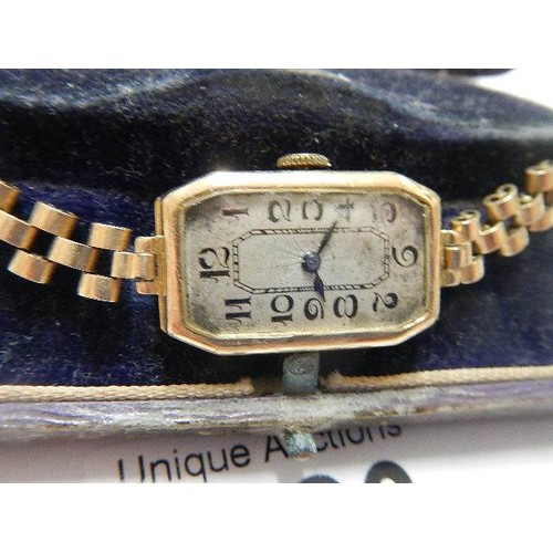 1126 - A 9ct gold ladies wrist watch on metal bracelet.