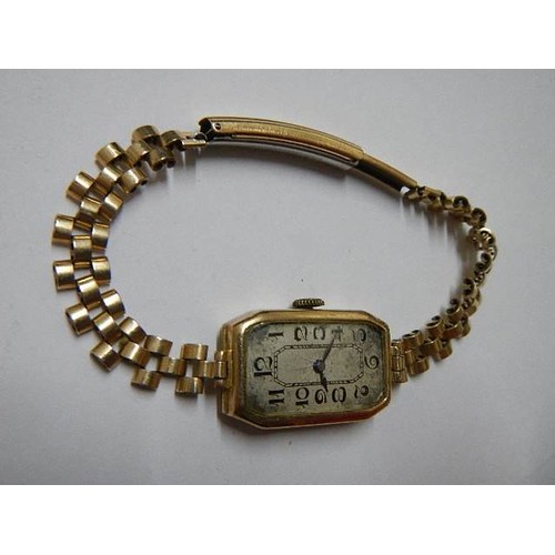 1126 - A 9ct gold ladies wrist watch on metal bracelet.